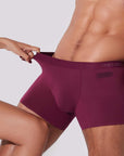 Man stretching burgundy boxer briefs showing flexible 4-way stretch fabric