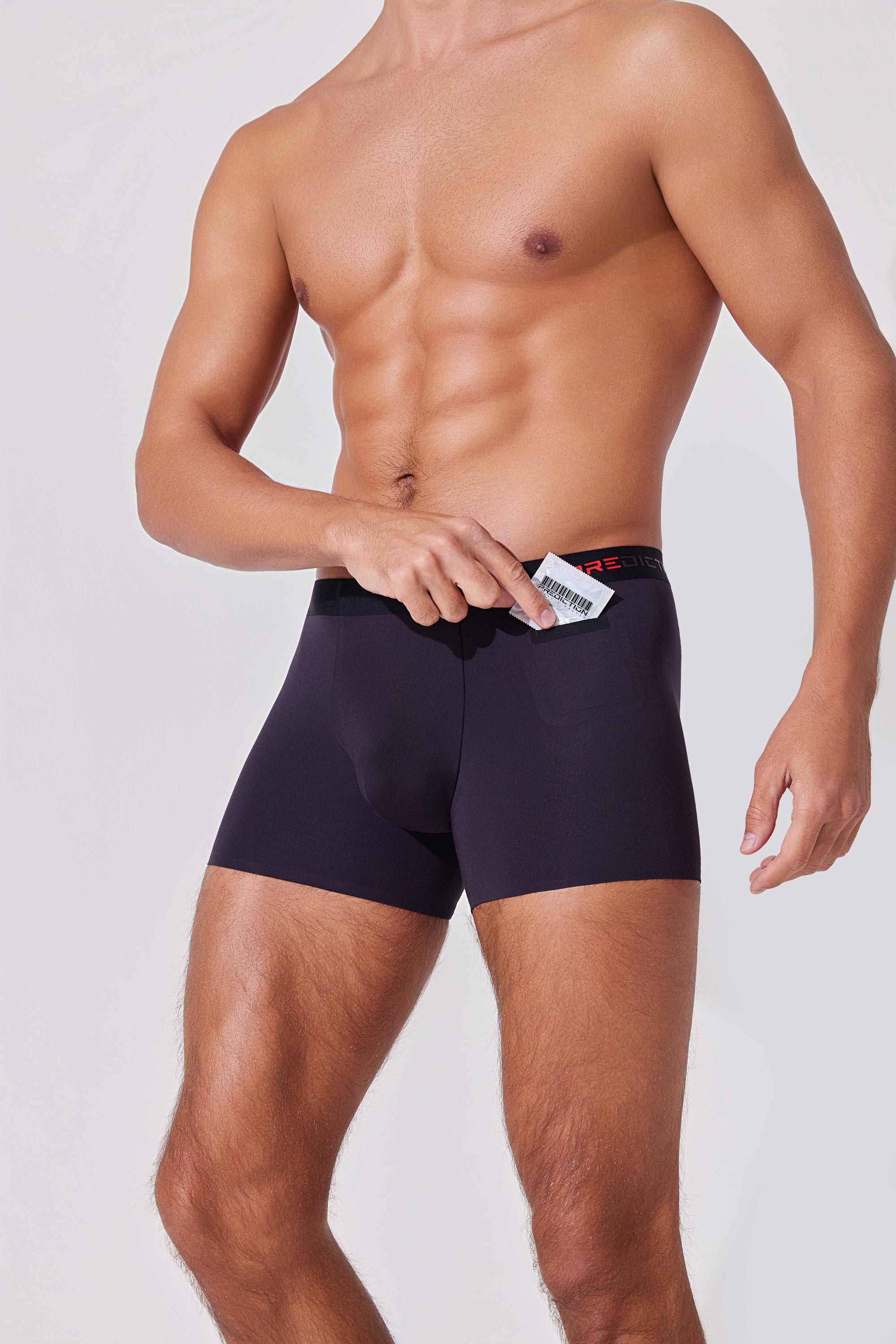 Men’s boxer briefs with hidden pocket holding condom for discreet carry