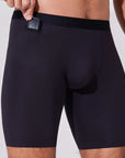 Man placing car key into pocket of black boxer briefs with patented pocket