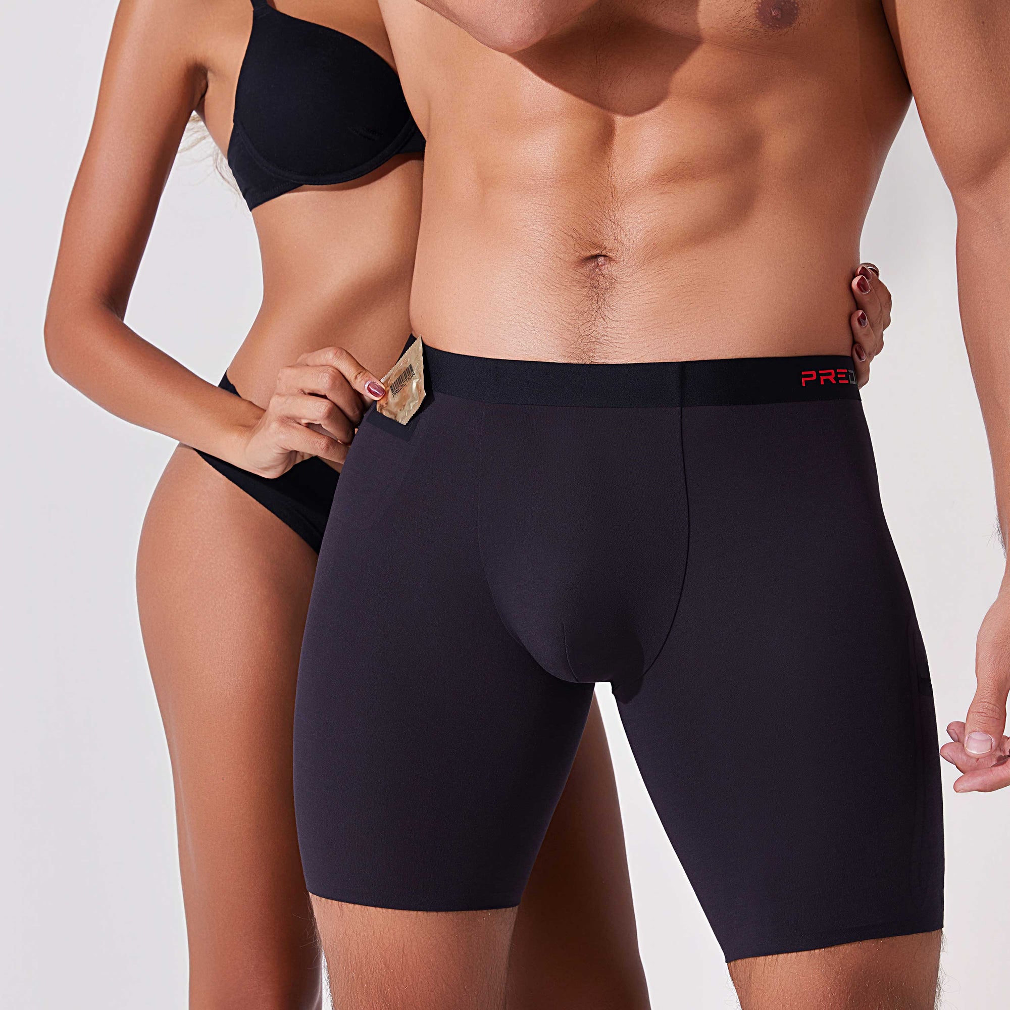 Couple using pocket in black boxer briefs to store condom discreetly
