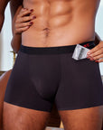 Man carrying condom in pocket of black boxer briefs with patented pocket
