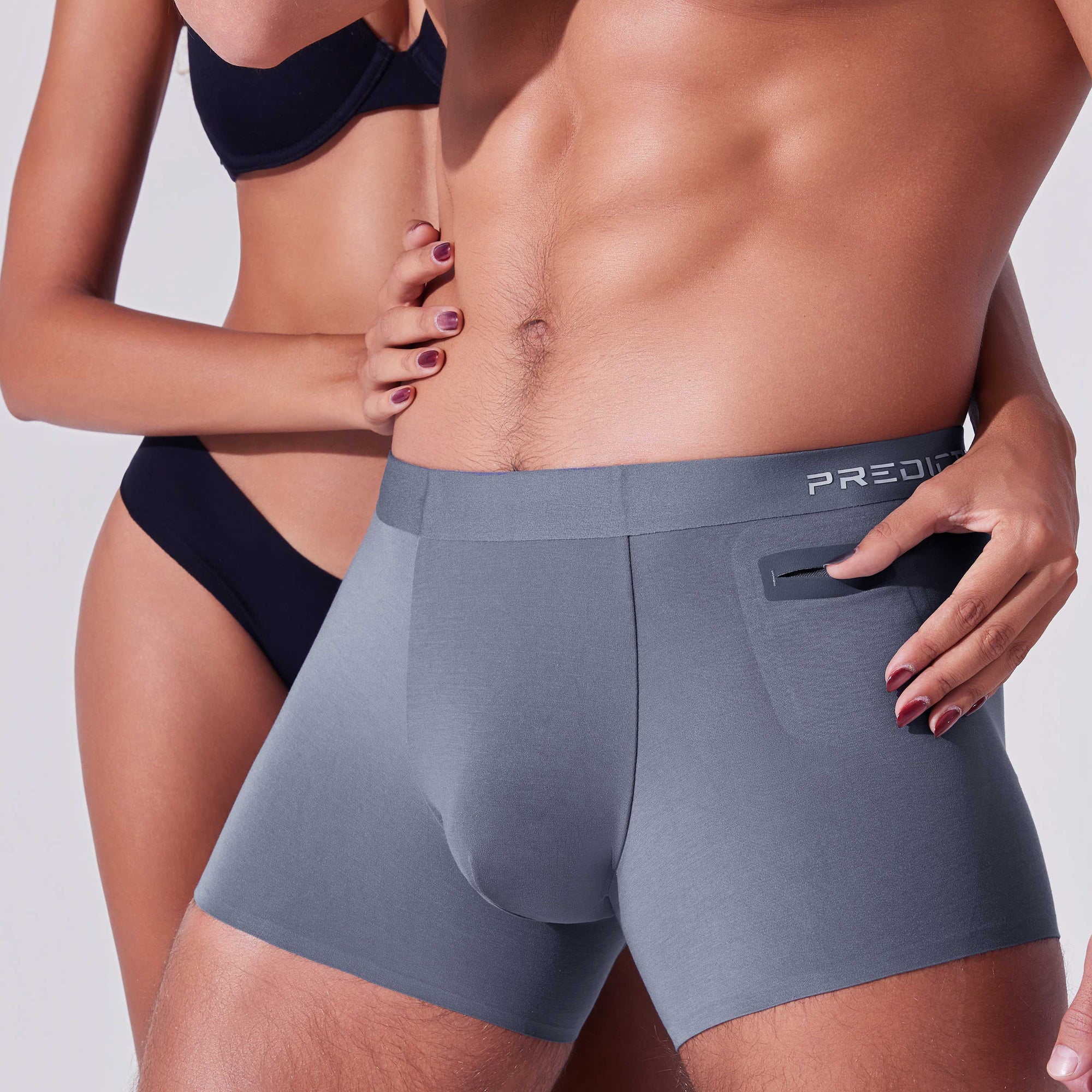 Men’s boxer briefs with hidden pocket being accessed showing easy reach storage
