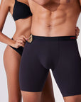 Woman pulling a condom from the hidden pocket of men’s boxer briefs showing smart and discreet storage
